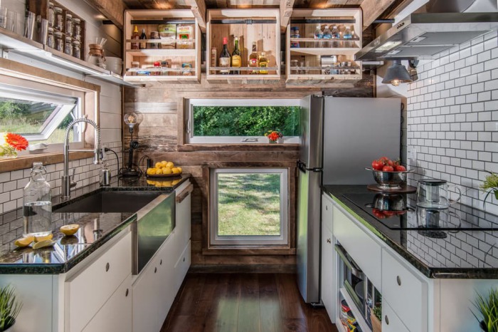 One kitchen wall and the ceiling are clad in reclaimed barn wood